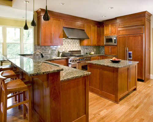 Baltic Brown Countertop, Baltic Brown Raised Breakfast Bar, Baltic Brown Island Top, Natural No Stain Cherry Cabinets, Light Oak Hardwood Flooring, Melange Gray Glass Subway Tile